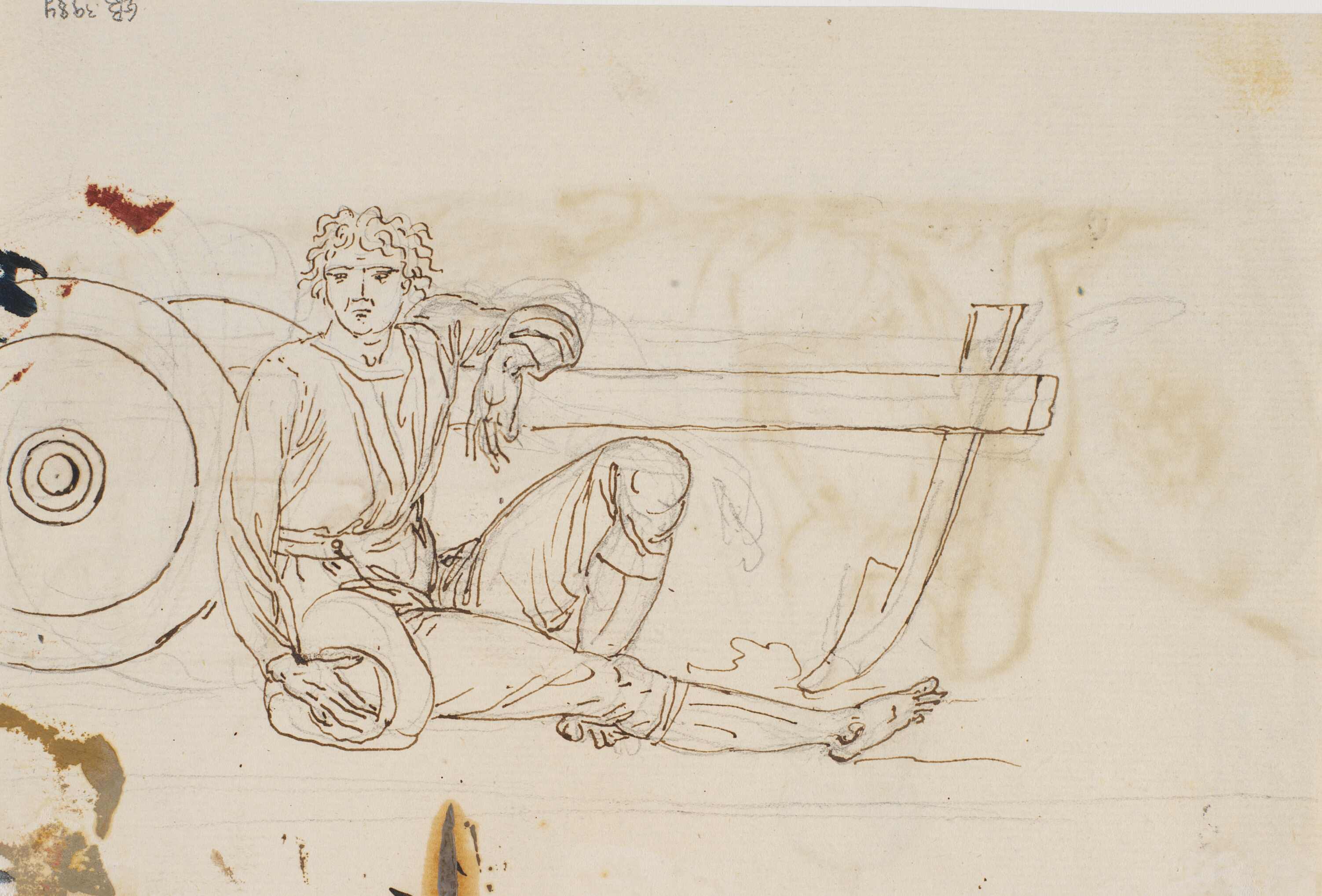 En siddende mand, støttet til en plov